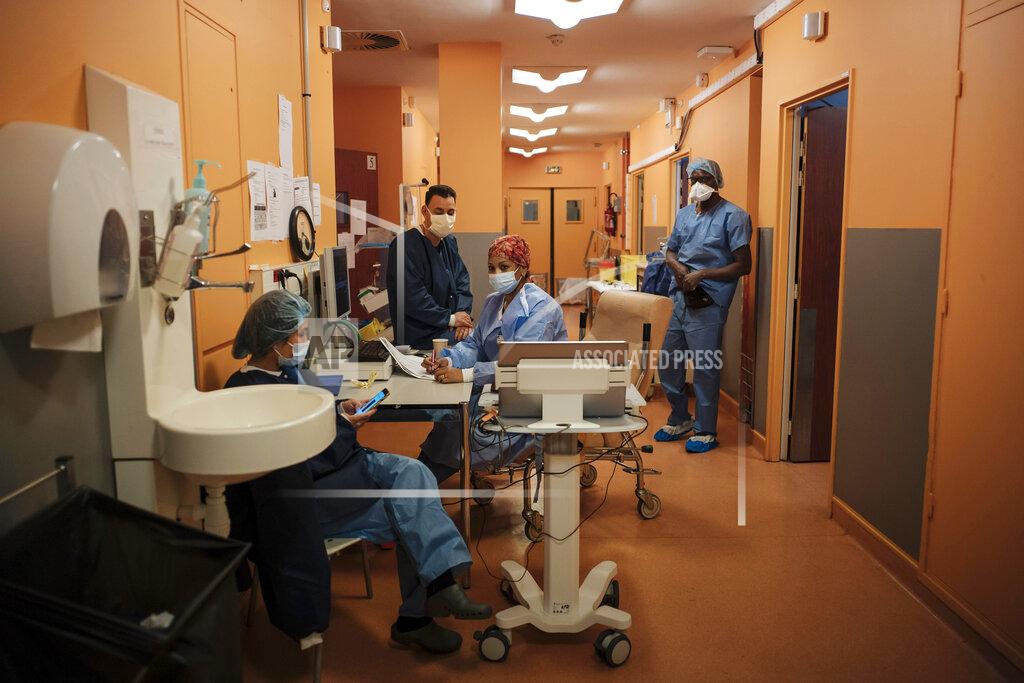 Lewis Joly Student nurse Soraya Ngin Tun, left, Dr. Atanas Sabahov, center left, nurse Rim Omrani, center right, and student nurse Landry Nzoyem, right, rest at Bichat Hospital, AP-HP, in Paris, Thursday, April 22, 2021. France still had nearly 6,000 critically ill patients in ICUs this week as the government embarked on the perilous process of gingerly easing the country out of its latest lockdown, too prematurely for those on pandemic frontlines in hospitals. President Emmanuel Macron's decision to reopen elementary schools on Monday and allow people to move about more freely again in May, even though ICU numbers have remained stubbornly higher than at any point since the pandemic's catastrophic first wave, marks another shift in multiple European capitals away from prioritizing hospitals. (AP Photo/Lewis Joly)