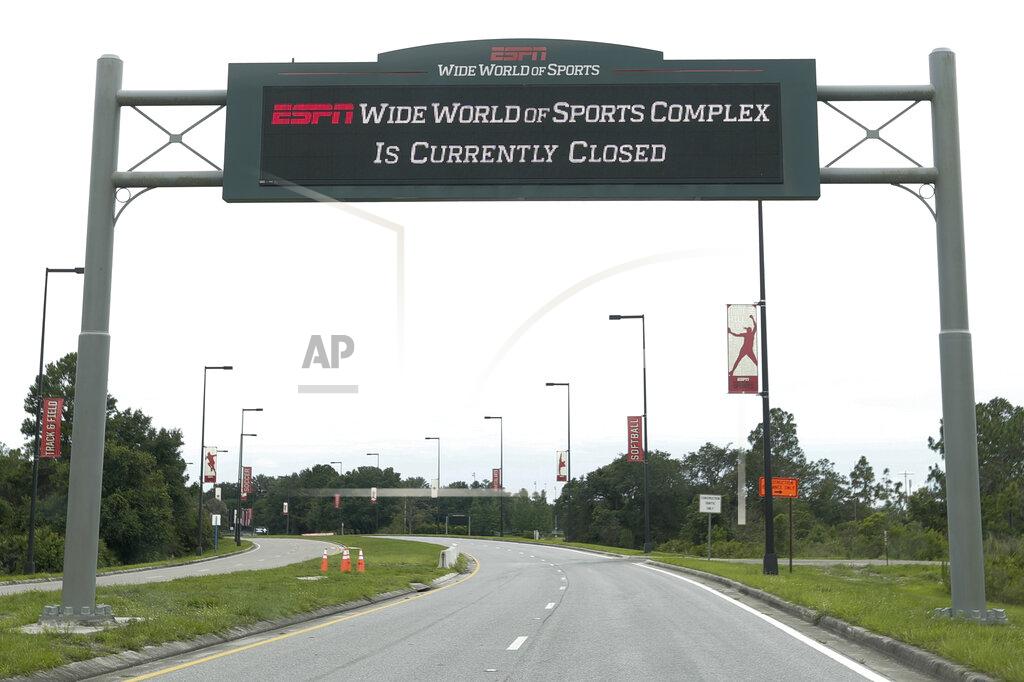 A sign at the entrance to ESPN's Wide World of Sports at Walt Disney World is seen Wednesday, June 3, 2020, in Kissimmee, Fla. The NBA has told the National Basketball Players Association that it will present a 22-team plan for restarting the season at Disney. (AP Photo/John Raoux)