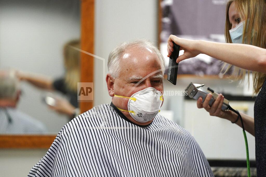 Anthony Souffle Gov. Tim Walz gets his hair cut by Erin Diede as he stopped in the morning at Capitol Barbers in the Minnesota State Office Building, Friday, June 5, 2020, in St. Paul, Minn. Walz went for a haircut and then toured some of the sites where vandalism occurred during the George Floyd protests. (Anthony Souffle/Star Tribune via AP)