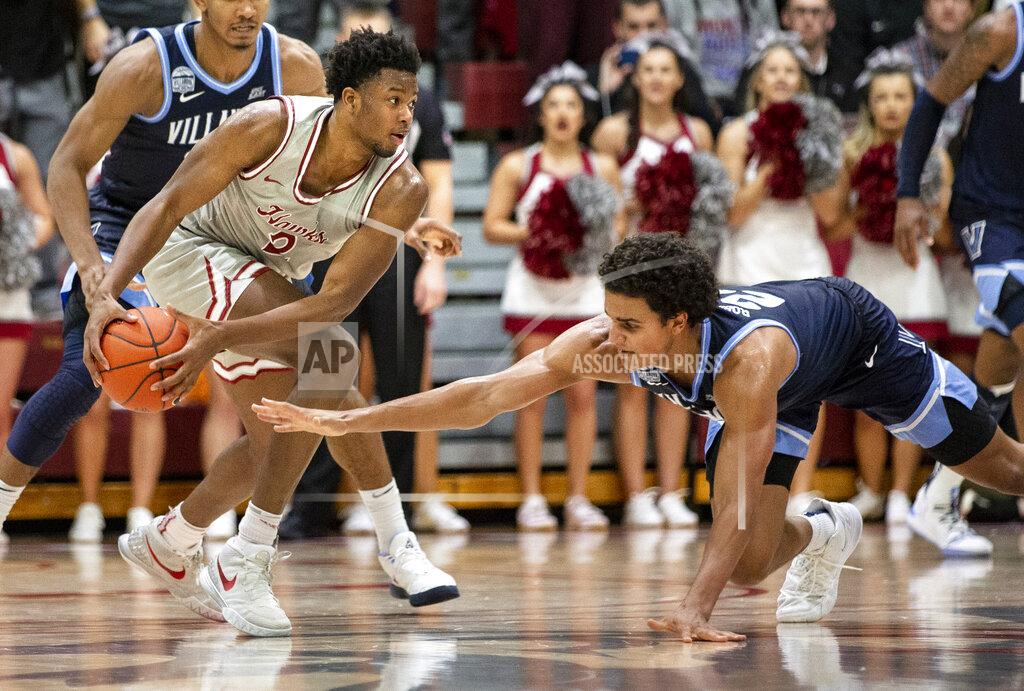 Laurence Kesterson Villanova forward Jeremiah Robinson-Earl (24) lunges for the ball as Saint Joseph's forward Myles Douglas (2) evades during the second half of an NCAA college basketball game, Saturday, Dec. 7, 2019, in Philadelphia. Villanova won 78-66. (AP Photo/Laurence Kesterson)