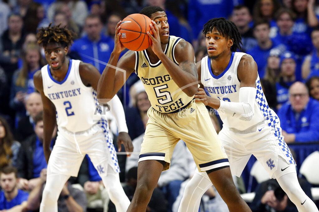 James Crisp Georgia Tech's Moses Wright, center, looks for an opening on Kentucky's Keion Brooks Jr., right, and Kahlil Whitney, left, during the first half of an NCAA college basketball game in Lexington, Ky., Saturday, Dec. 14, 2019. (AP Photo/James Crisp)