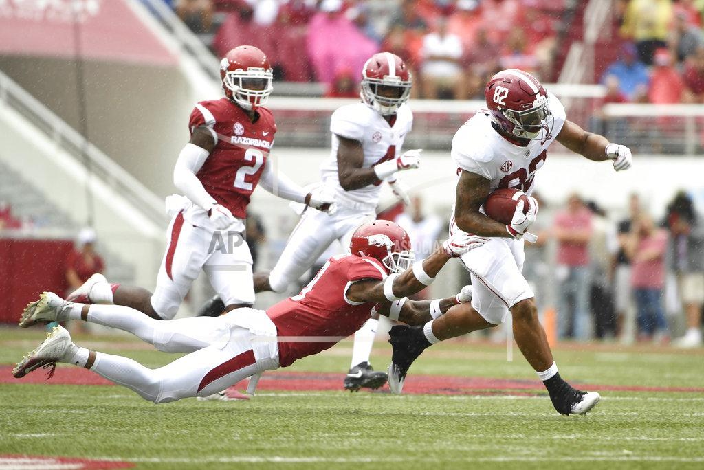 Michael Woods Alabama receiver Irv Smith Jr. slips past Arkansas defender Santos Ramirez in the first half of an NCAA college football game Saturday, Oct. 6, 2018, in Fayetteville, Ark. (AP Photo/Michael Woods)