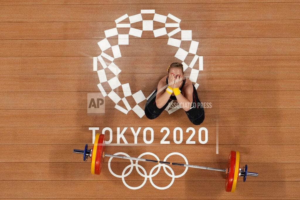 Luca Bruno Sabine Beate Kusterer of Germany gestures after an unsuccessful lift during the women's 59kg weightlifting event, at the 2020 Summer Olympics, Tuesday, July 27, 2021, in Tokyo, Japan. (AP Photo/Luca Bruno)