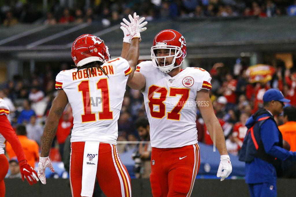 Kansas City Chiefs tight end Travis Kelce, right, celebrates with teammate wide receiver Demarcus Robinson after scoring a touchdown during the second half of an NFL football game against the Los Angeles Chargers, Monday, Nov. 18, 2019, in Mexico City. (AP Photo/Rebecca Blackwell)