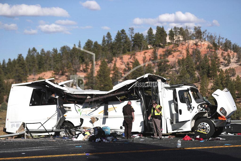 Spenser Heaps FILE - In this Sept. 20, 2019, file photo, authorities work the scene of a tour bus crash near Bryce Canyon National Park in Utah. The families of Chinese tourists killed or injured in the crash say the state's design and maintenance failed to keep the remote highway safe. (Spenser Heaps/The Deseret News via AP, File)