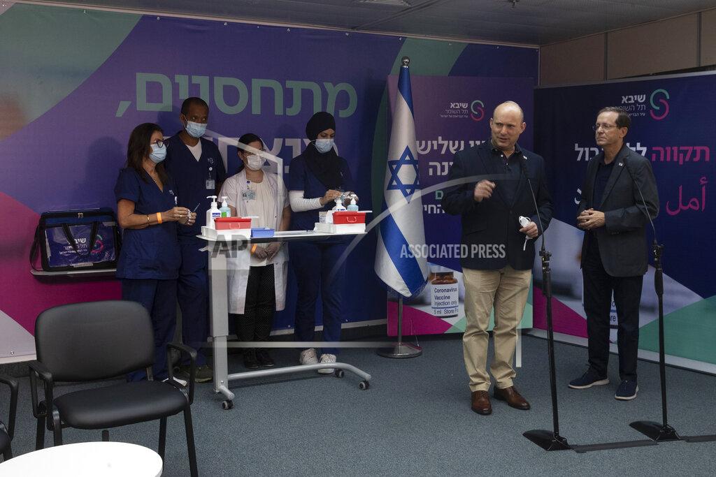 Maya Alleruzzo Israeli Prime Minister Naftali Bennett, front left, speaks to journalists with President Isaac Herzog, who received a third coronavirus vaccine at the Sheba Medical Center in Ramat Gan, Israel, Friday, July 30, 2021.(AP Photo/Maya Alleruzzo, Pool)