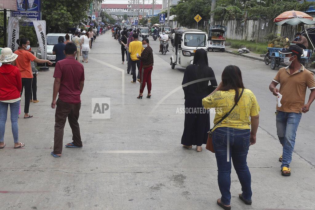 Heng Sinith Villagers line up on a street as they wait to get their first dose of the Sinovac COVID-19 vaccine at an injection center near Tuol Sangke main market, in Phnom Penh, Cambodia, Monday, May 24, 2021. (AP Photo/Heng Sinith)