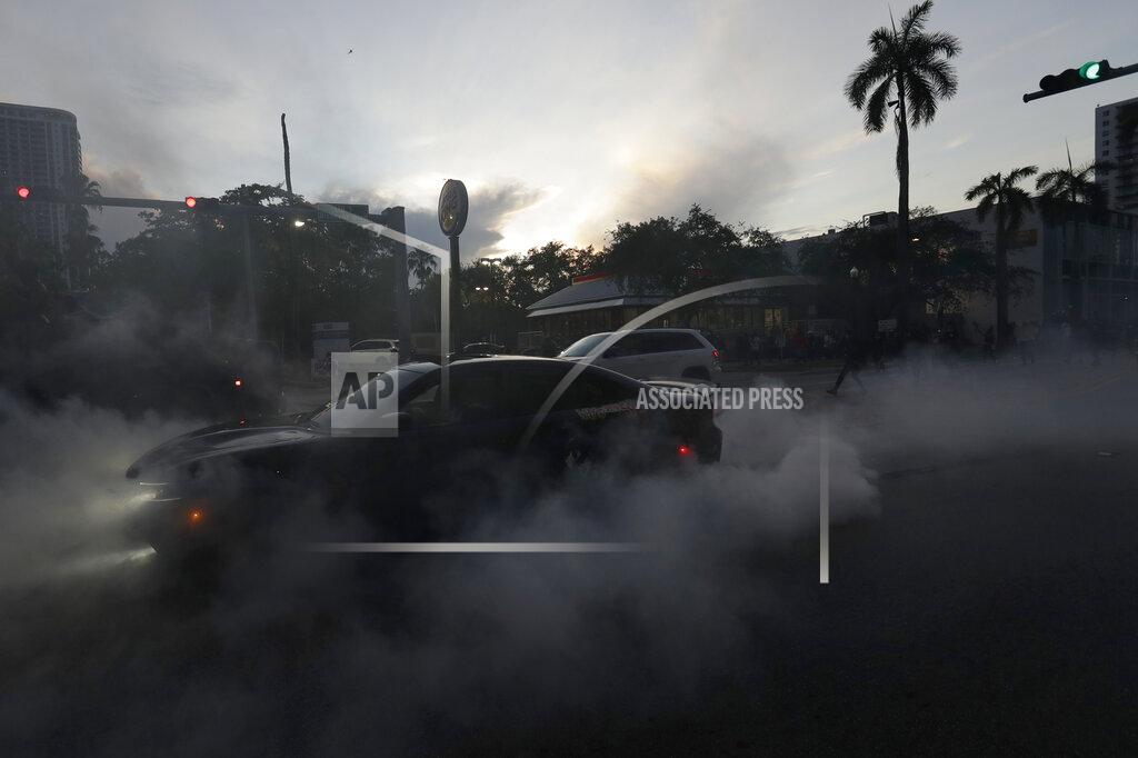 Wilfredo Lee A protester does a burnout as he and others demonstrate over the death of George Floyd, Sunday, May 31, 2020, in Miami. Floyd died after being restrained by Minneapolis police officers on May 25. (AP Photo/Wilfredo Lee)