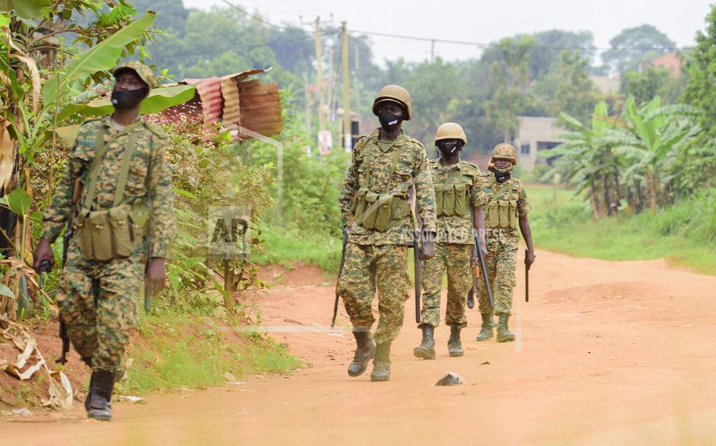 Nicholas Bamulanzeki Soldiers patrol outside opposition challenger Bobi Wine's home in Magere, Kampala, Uganda, Saturday, Jan. 16, 2021, after President Yoweri Museveni was declared the winner of the presidential election. Uganda’s electoral commission says longtime President Yoweri Museveni has won a sixth term, while top opposition challenger Bobi Wine alleges rigging and officials struggle to explain how polling results were compiled amid an internet blackout. In a generational clash widely watched across the African continent, the young singer-turned-lawmaker Wine posed arguably the greatest challenge yet to Museveni. (AP Photo/Nicholas Bamulanzeki)