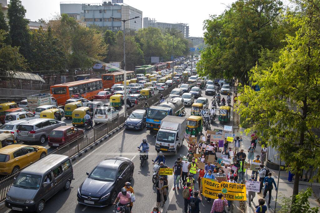 Altaf Qadri Student activists carry posters and shout slogans as they participate in a protest march against climate change in New Delhi, India, Friday, March 19, 2021. India has ambitions to expand use of electric vehicles to wean itself from polluting fossil fuels, but EVs are still a rarity on its congested highways. A lack of charging stations and poor quality batteries are discouraging drivers from switching over. (AP Photo/Altaf Qadri)