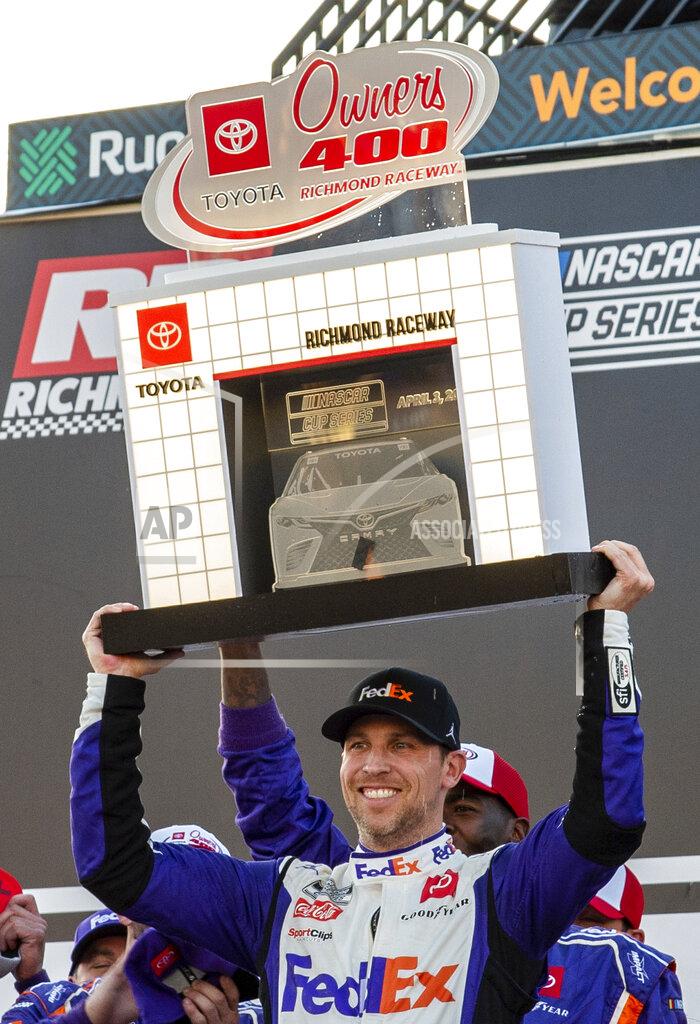 Mike Caudill Denny Hamlin holds the trophy after winning the NASCAR Cup Series auto race at Richmond Raceway on Sunday, April 3, 2022, in Richmond, Va. (AP Photo/Mike Caudill)