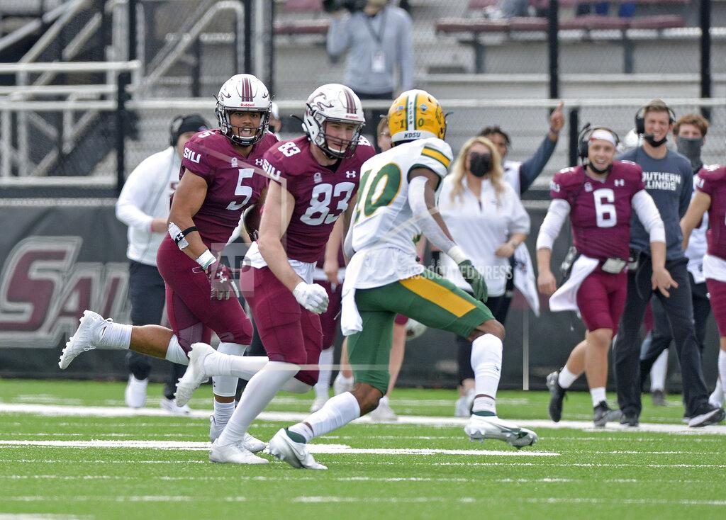 Byron Hetzler Southern Illinois running back Justin Strong (5) looks for a block from wide receiver Branson Combs (83) against North Dakota State free safety Dom Jones (10) during the second quarter of an NCAA college football game Saturday, Feb. 29, 2021, in Carbondale, Ill. (Byron Hetzler/The Southern Illinoisan via AP)
