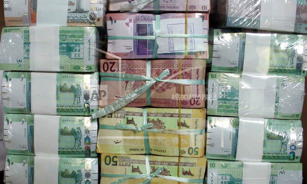 FILE - In this Sunday, July 24, 2011 file photo, Sudan's banknotes are displayed behind a window at the central bank in Khartoum, Sudan. Sudan's annual inflation has hit a new record peak as prices of bread and other staples keep surging, according to official figures released on Tuesday. (AP Photo/Abd Raouf, File)
