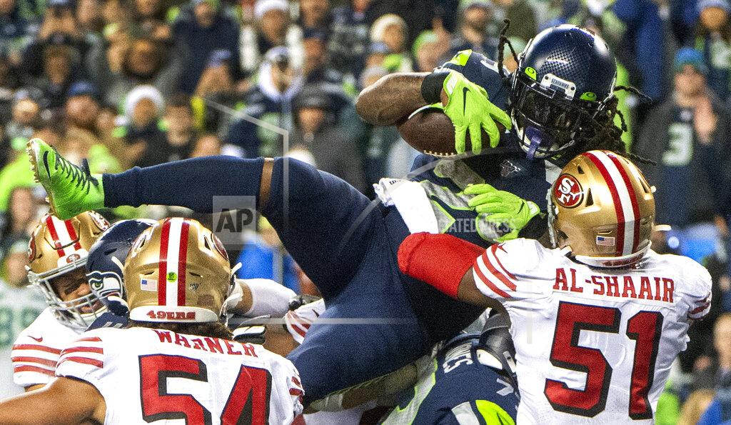 Drew Perine Seattle Seahawks running back Marshawn Lynch leaps over the pile to score a touchdown in the fourth quarter of an NFL football game in Seattle on Sunday, Dec. 29, 2019. (Drew Perine/The News Tribune via AP)