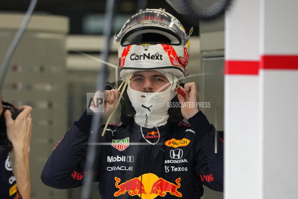 Hassan Ammar Red Bull driver Max Verstappen of the Netherlands adjusts helmet during practice session for the Saudi Arabian Grand Prix in Jiddah, Friday, Dec. 3, 2021. (AP Photo/Hassan Ammar)
