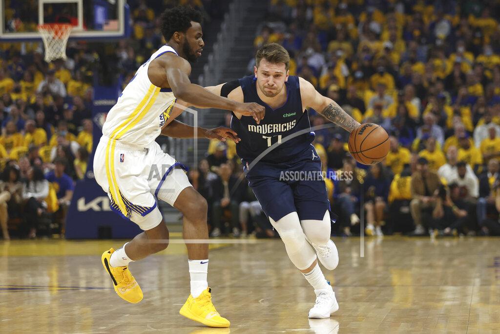 Jed Jacobsohn Dallas Mavericks guard Luka Doncic, right, drives to the basket against Golden State Warriors forward Andrew Wiggins during the first half of Game 2 of the NBA basketball playoffs Western Conference finals in San Francisco, Friday, May 20, 2022. (AP Photo/Jed Jacobsohn)