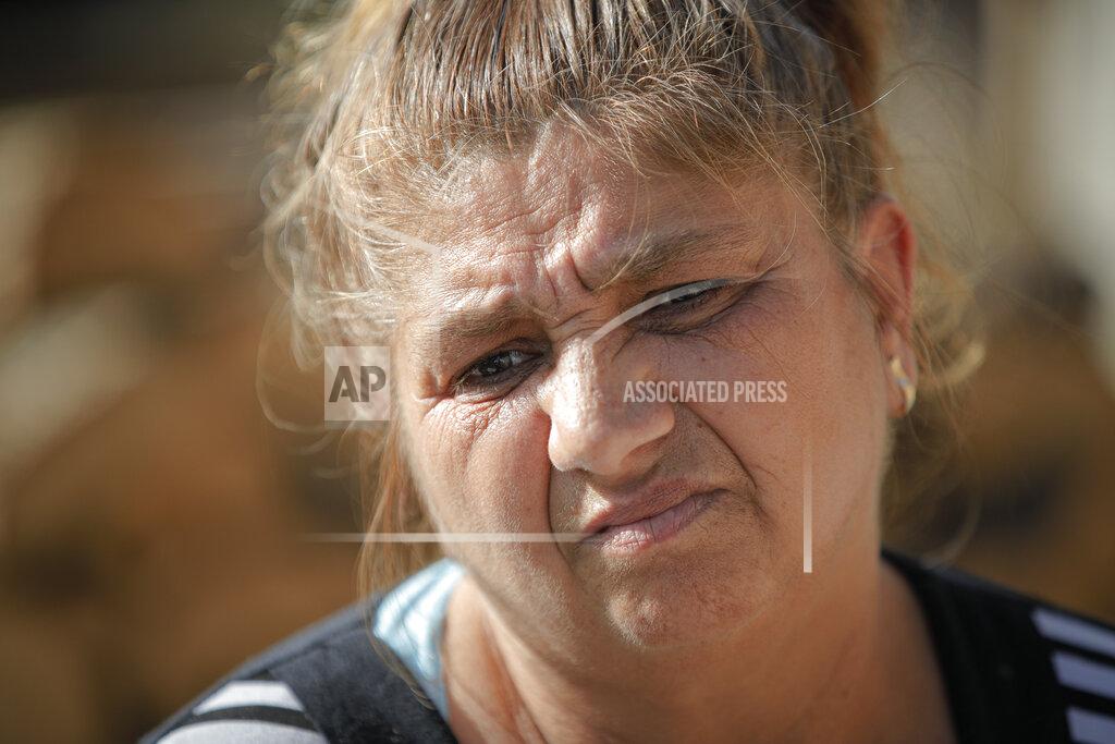 Vadim Ghirda Azime Ali Topchu, 48, a Bulgarian Roma woman, pauses during an interview with the Associated Press in a village on the outskirts of Burgas, Bulgaria, Monday, Sept. 28, 2020. Human rights activists and experts say local officials in several countries with significant Roma populations have used the pandemic to unlawfully target the minority group, which is Europe's largest and has faced centuries of severe discrimination. Topchu said that the police-enforced lockdown of her village in Burgas, on Bulgaria's Black Sea Coast, made her family "really sad." (AP Photo/Vadim Ghirda)