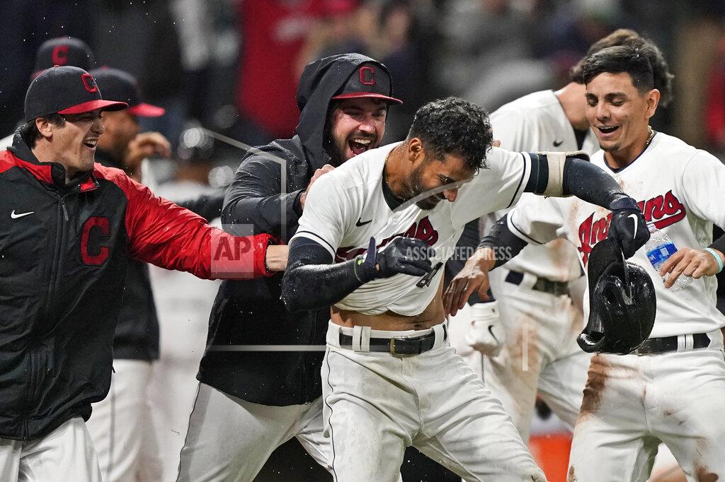 Tony Dejak Cleveland Indians' Oscar Mercado, center, is mobbed by teammates after hitting a two-run home run in the seventh inning in the second baseball game of a doubleheader against the Chicago White Sox, Thursday, Sept. 23, 2021, in Cleveland. (AP Photo/Tony Dejak)