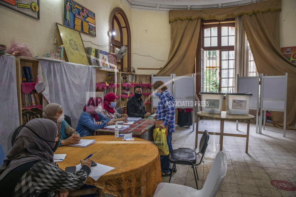 Nariman El-Mofty A woman prepares to vote on the first day in the second and final stage of the country's parliamentary elections in Cairo, Egypt, Saturday, Nov. 7, 2020. Egyptians began voting on Saturday after a relatively low turnout in the first stage that embarrassed the government of President Abdel-Fattah el-Sissi. (AP Photo/Nariman El-Mofty)