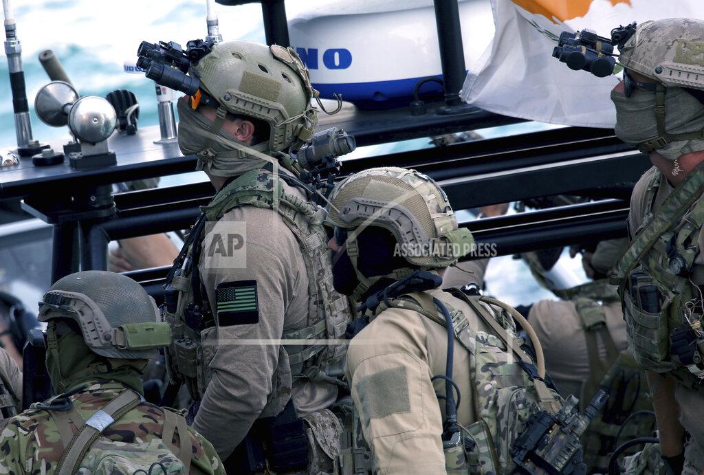 Philippos Christou A U.S. Navy SEAL special forces operator, second left, and colleagues during a joint U.S.-Cyprus military drill at Limassol port on Friday, Sept. 10, 2021. Cyprus' Defense Minister Charalambos Petrides said the U.S. and Cyprus are on the same strategic path to ensure security and stability in a turbulent region and that continued close cooperation between the special forces of both countries aim to counter threats from potential terrorist acts. (AP Photo/Philippos Christou)