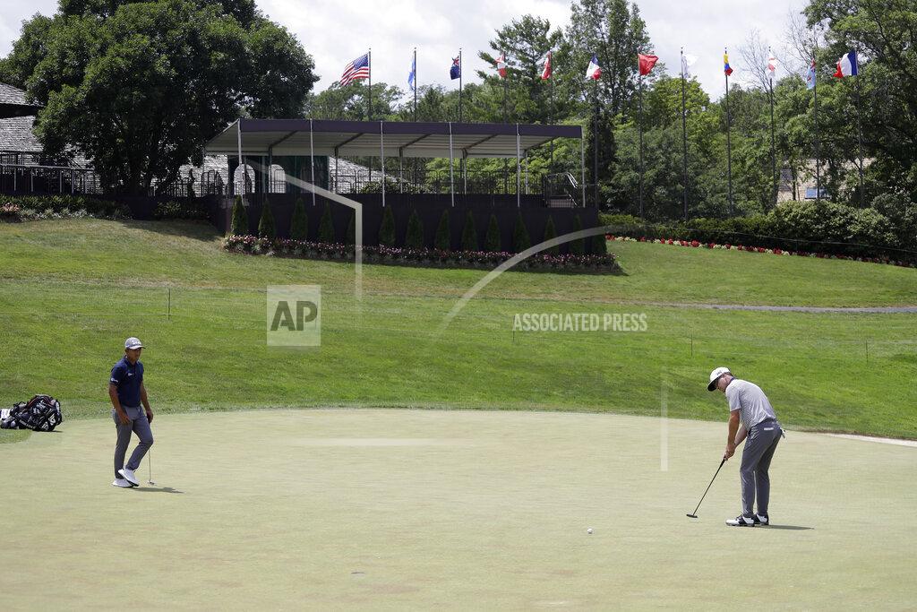 Darron Cummings Zach Johnson, right, putts on the 18th green next to C. T. Pan, of Taipei, during the final round of the Memorial golf tournament, Sunday, July 19, 2020, in Dublin, Ohio. (AP Photo/Darron Cummings)