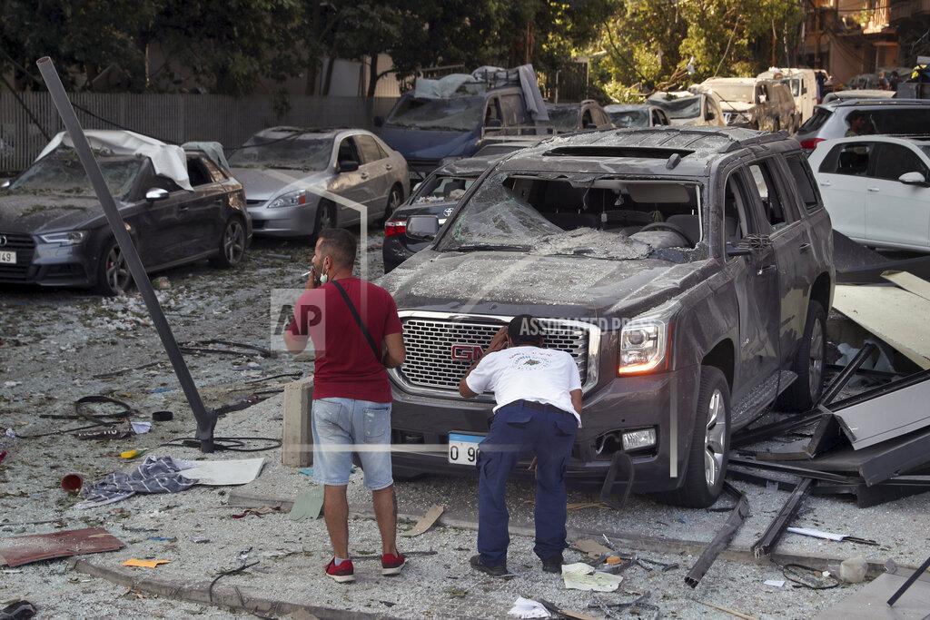 Bilal Hussein A man inspects his a damaged car after a massive explosion on Tuesday, in Beirut, Lebanon, Wednesday, Aug. 5, 2020. The explosion flattened much of a port and damaged buildings across Beirut, sending a giant mushroom cloud into the sky. In addition to those who died, more than 3,000 other people were injured, with bodies buried in the rubble, officials said. (AP Photo/Bilal Hussein)