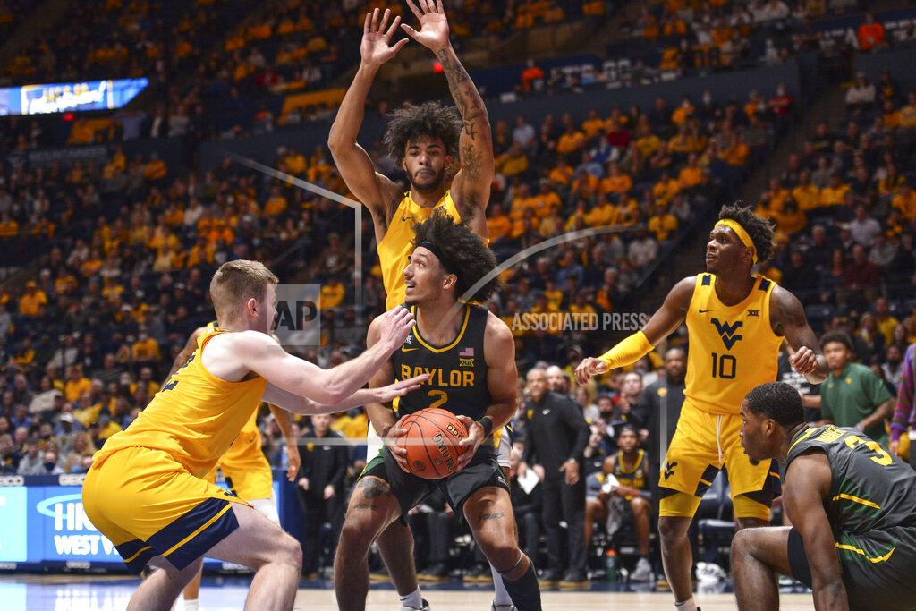 William Wotring Baylor guard Kendall Brown (2) protects the ball from West Virginia guard Sean McNeil (22) during the second half of an NCAA college basketball game in Morgantown, W.Va., Tuesday, Jan. 18, 2022. (William Wotring)