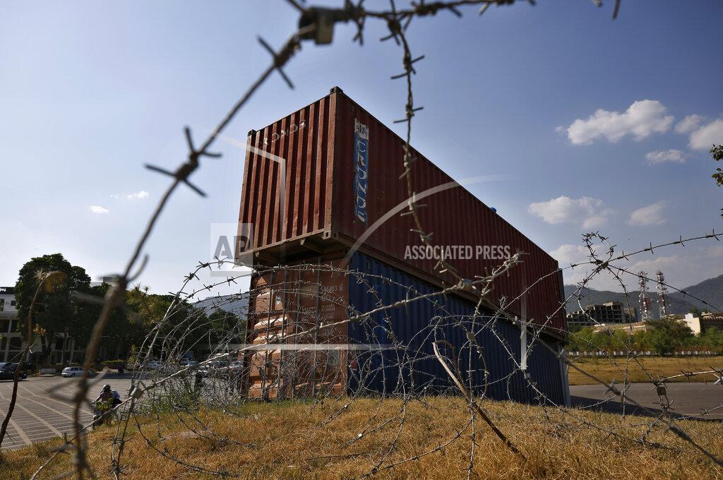 Anjum Naveed Shipping containers placed by authorities block a road leading to important government buildings in an attempt to foil a planned rally by Pakistan's key opposition party, in Islamabad, Pakistan, Tuesday, May 24, 2022. Pakistan banned ousted Prime Minister Imran Khan from holding a massive rally in the capital of Islamabad and cracked down on his supporters in overnight raids across the country, arresting hundreds. (AP Photo/Anjum Naveed)