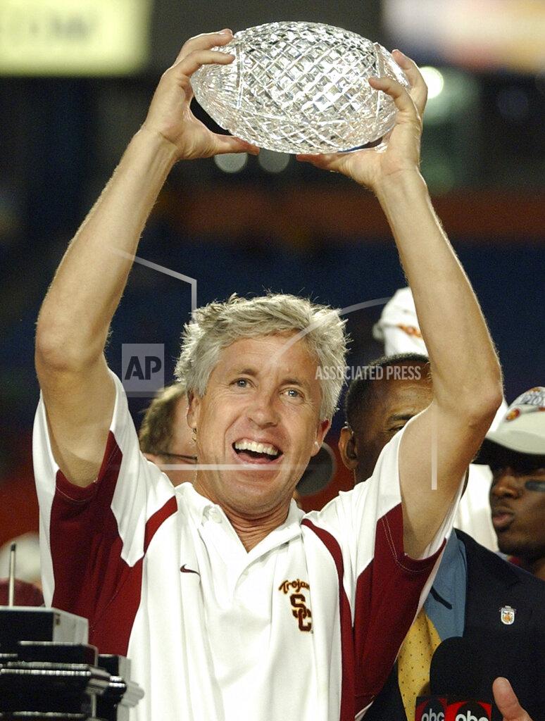 Chris O'meara FILE - In this Jan. 4, 2005, file photo, Southern Cal coach Pete Carroll holds up the trophy after defeating Oklahoma 55-19 in the Orange Bowl at Pro Player Stadium in Miami. In the 80-year history of The Associated Press college football poll, no team has had a longer uninterrupted run at No. 1 than coach Pete Carroll’s Southern California Trojans. (AP Photo/Chris O'Meara, File)