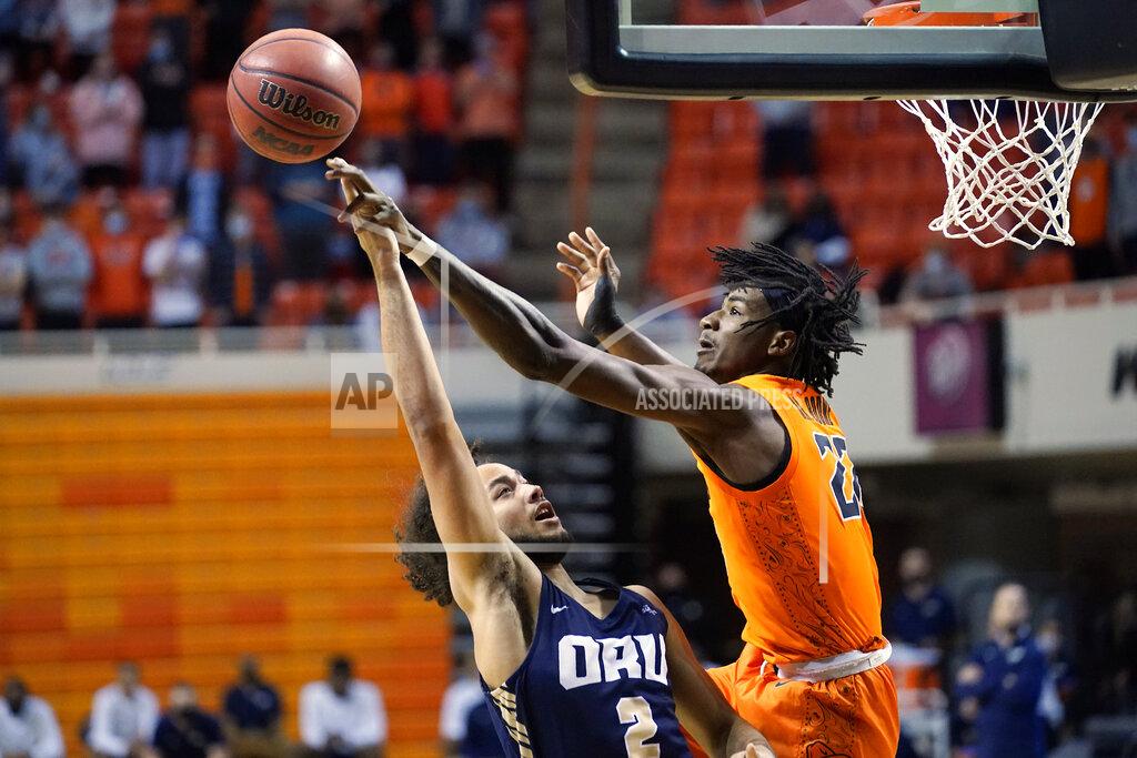 Sue Ogrocki Oklahoma State forward Kalib Boone (22) blocks a shot by Oral Roberts guard Kareem Thompson (2) during the first half of an NCAA college basketball game Tuesday, Dec. 8, 2020, in Stillwater, Okla. (AP Photo/Sue Ogrocki)
