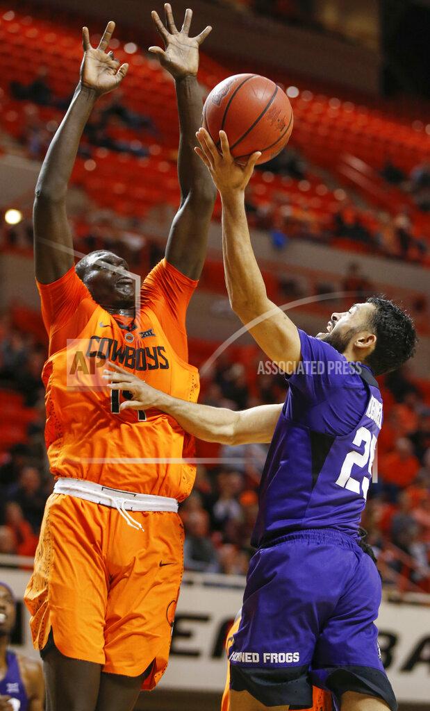Nate Billings TCU's Alex Robinson (25) shoots as Oklahoma State's Yor Anei (14) defends in the second half of a NCAA college basketball game in Stillwater, Okla., Monday, Feb. 18, 2019. (Nate Billings/The Oklahoman via AP)