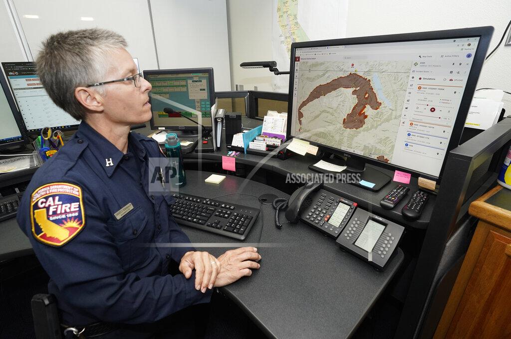 Rich Pedroncelli CORRECTS SPELLING OF FIRST NAME TO DANELL, NOT DANELLE - Cal Fire Capt. Danell Eshnaur uses the Fire Response Tactical Analyst program to use computer modeling to help pre-position fire fighting resources on the Dixie Fire at the California Department of Forestry and Fire Protection's Sacramento Command Center in Rancho Cordova, Calif., Friday, July 23, 2021. Firefighters are trying to become smarter in how they prepare for the drought- and wind-driven wildfires that have become more dangerous across the American West in recent years, including by using new technology like fire behavior computer modeling that can help assess risks before fires start, then project their path and growth. (AP Photo/Rich Pedroncelli)