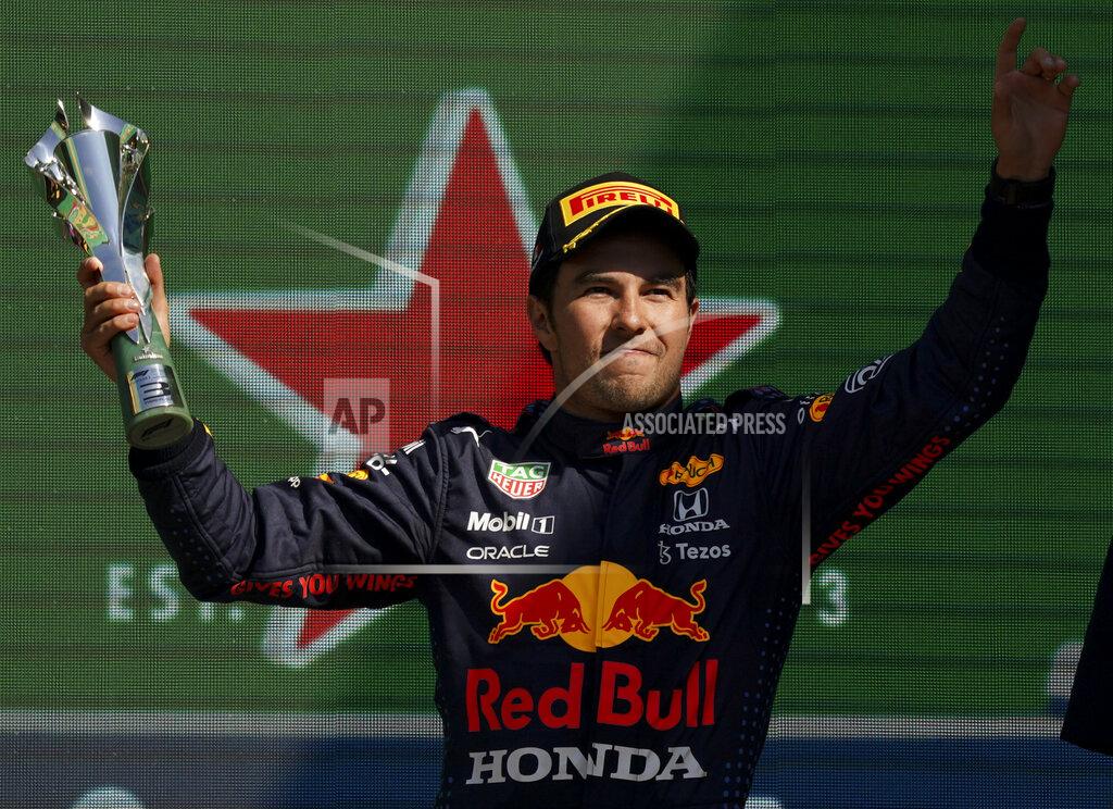 Fernando Llano Red Bull's Sergio Perez celebrates winning third place of the Formula One Mexico Grand Prix auto race at the Hermanos Rodriguez racetrack in Mexico City, Sunday, Nov. 7, 2021. (AP Photo/Fernando Llano)