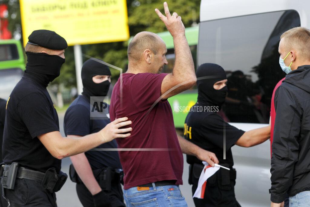 Sergei Grits Police detain a protester to prevent a rally in support of opposition candidate Sviatlana Tsikhanouskaya ahead of Sunday's election in Slutsk, Belarus, Tuesday, Aug. 4, 2020. Belarusian police on Tuesday, abruptly banned Tsikhanouskaya's previously approved rally in the city of Slutsk, about 100 kilometers (about 60 miles) south of Minsk, under the pretext of road repairs. Officers dispersed several hundred people who had gathered for the rally and detained at least 20 of them, according to Belarusian human rights organization Viasna. (AP Photo/Sergei Grits)