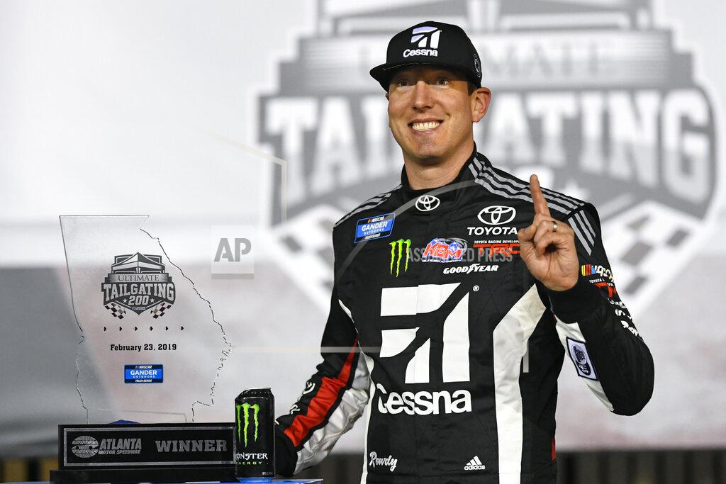 John Amis Kyle Busch poses with the trophy after winning the NASCAR Truck Series auto race at Atlanta Motor Speedway, Saturday, Feb. 23, 2019, in Hampton, Ga. (AP Photo/John Amis)