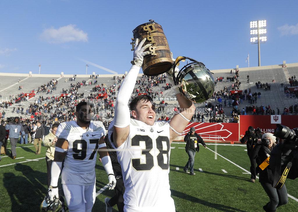 Darron Cummings Purdue's Brennan Thieneman holds the Old Oaken Bucket after Purdue defeated Indiana, 28-21, in an NCAA college football game, Saturday, Nov. 24, 2018, in Bloomington, Ind. (AP Photo/Darron Cummings)