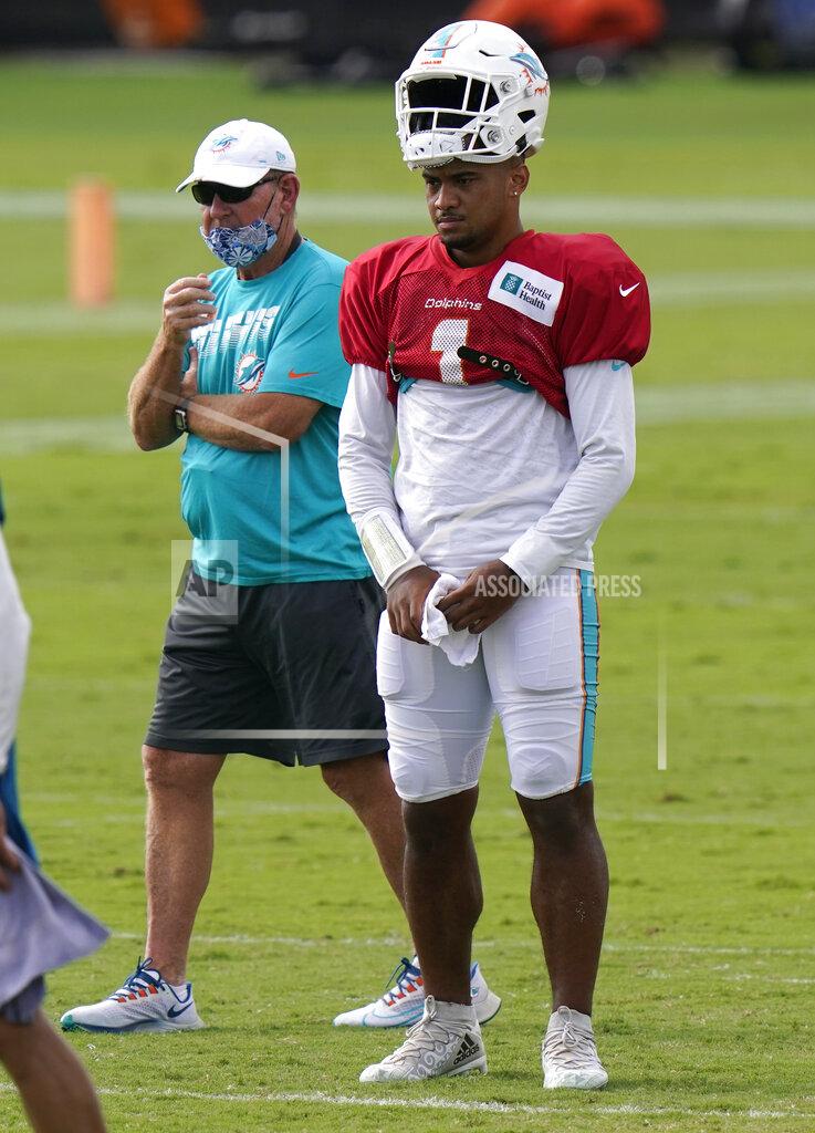 Lynne Sladky Miami Dolphins quarterback Tua Tagovailoa (1) and offensive coordinator Chan Gailey, left, stand on the field during practice at the NFL football team's training facility, Tuesday, Aug. 25, 2020, in Davie, Fla. (AP Photo/Lynne Sladky)