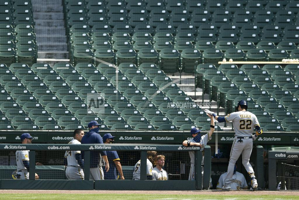 Paul Beaty Milwaukee Brewers' Christian Yelich (22) celebrates with manager Craig Counsell at the dugout after hitting a two-run home run during the sixth inning of a baseball game against the Chicago Cubs, Saturday, July 25, 2020, in Chicago. (AP Photo/Paul Beaty)