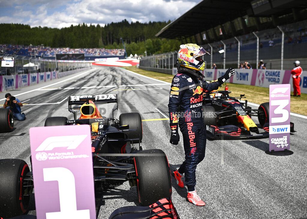 Christian Bruna Red Bull driver Max Verstappen of the Netherlands waves in the winners circle after he placed first to take pole position during the qualifying session ahead of the Austrian Formula One Grand Prix at the Red Bull Ring racetrack in Spielberg, Austria, Saturday, July 3, 2021. The Austrian Grand Prix will be held on Sunday. (Christian Bruna/Pool Photo via AP)