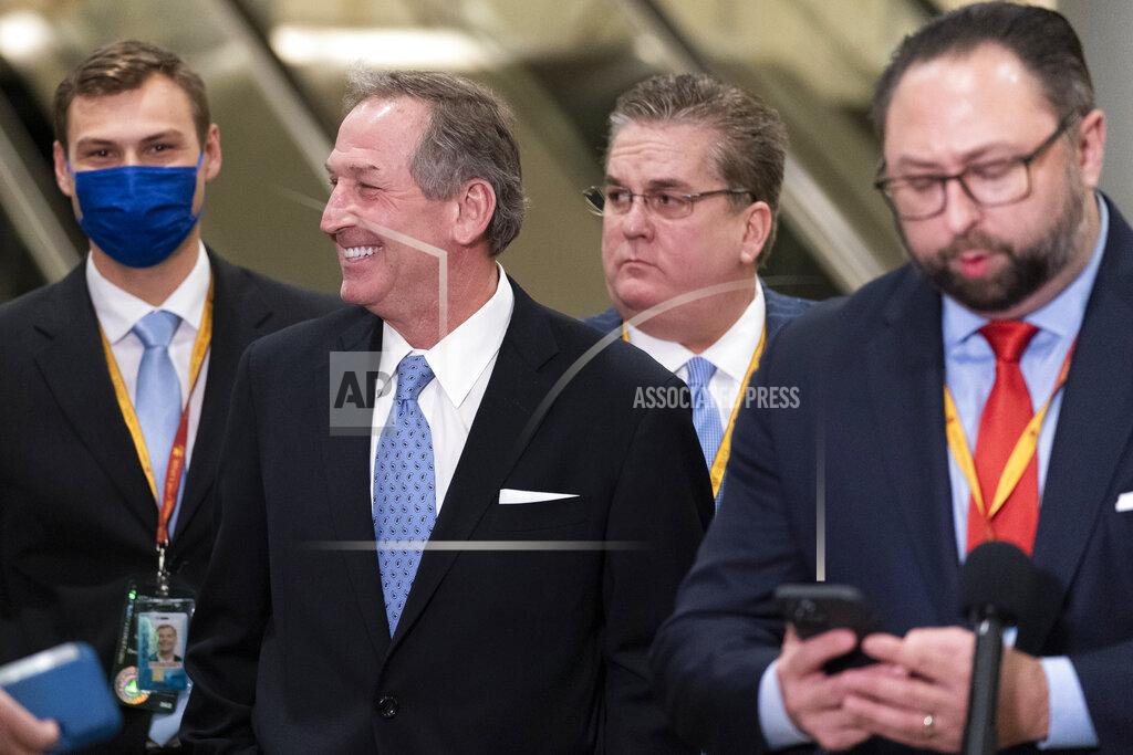 Alex Brandon Michael van der Veen, second from left, an attorney from former President Donald Trump, smiles at reporters on Capitol Hill after the Senate acquitted Trump in his second impeachment trial in the Senate at the U.S. Capitol in Washington, Saturday, Feb. 13, 2021. Trump was accused of inciting the Jan. 6 attack on the U.S. Capitol, and the acquittal gives him a historic second victory in the court of impeachment. Jason Miller, former senior advisor to 2020 Trump campaign, stands at right. (AP Photo/Alex Brandon)