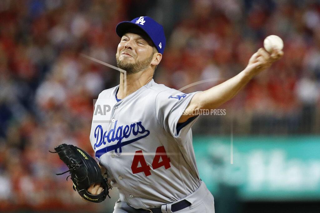FILE - In this Oct. 7, 2019, file photo, Los Angeles Dodgers starting pitcher Rich Hill throws against the Washington Nationals during the first inning in Game 4 of a baseball National League Division Series in Washington. Hill has won the Tony Conigliaro Award. The honor goes to a major leaguer “who has overcome adversity through the attributes of spirit, determination and courage that were the trademarks of Tony C.” (AP Photo/Alex Brandon, File)