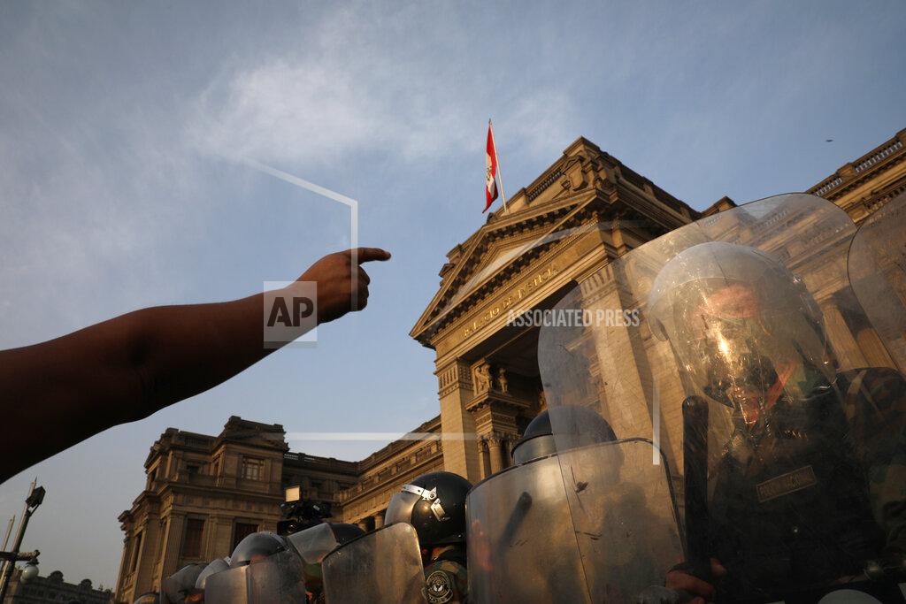 Rodrigo Abd Police form a cordon in front of the Justice Palace as people who are refusing to recognize the new government arrive, in Lima, Peru, Wednesday, Nov. 11, 2020. On Tuesday, Peru swore in Manuel Merino as president, after Peru’s legislature booted President Martin Vizcarra from office on Monday. (AP Photo/Rodrigo Abd)