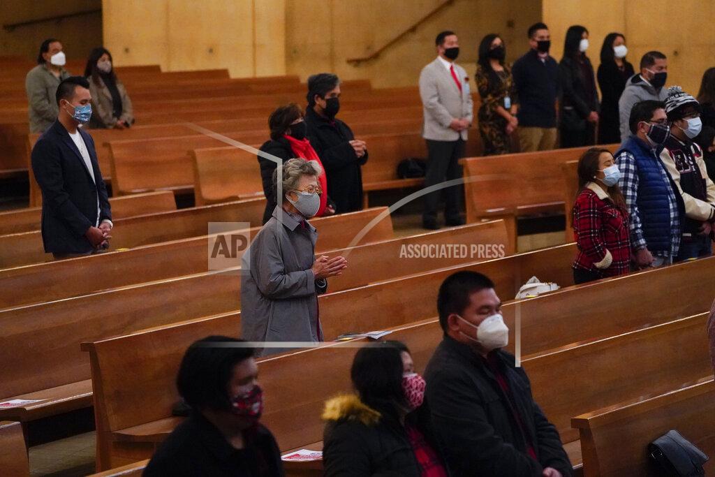 Ashley Landis Worshipers gather for a Christmas Eve Mass inside the Cathedral of Our Lady of the Angels, Thursday, Dec 24, 2020, in Los Angeles. California became the first state to record 2 million confirmed coronavirus cases, reaching the milestone on Christmas Eve as nearly the entire state was under a strict stay-at-home order and hospitals were flooded with the largest crush of cases since the pandemic began. (AP Photo/Ashley Landis)