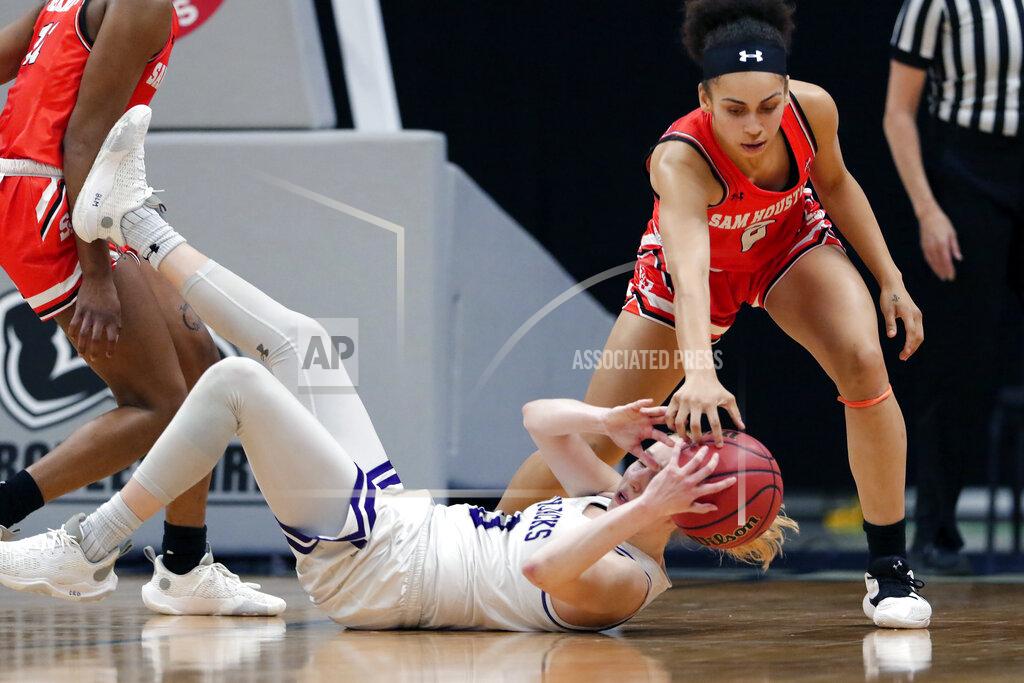 Michael Wyke Stephen F. Austin guard Stephanie Visscher (13) has the loose ball knocked away by Sam Houston State forward Amber Leggett, right, during the second half of an NCAA college basketball game for the Southland Conference women's tournament championship Sunday, March 14, 2021, in Katy, Texas. (AP Photo/Michael Wyke)