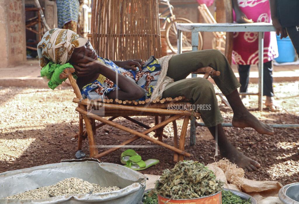 In this Wednesday, May 13, 2020, photo, a child sleeps at a market stall selling food in Tougan, Burkina Faso. Violence linked to Islamic extremists has spread to Burkina Faso's breadbasket region, pushing thousands of people toward hunger and threatening to cut off food aid for millions more. (AP Photo/Sam Mednick)