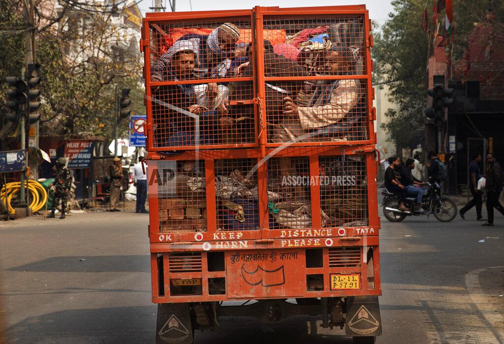 Rajesh Kumar Singh FILE - In this Wednesday, Feb. 26, 2020, file photo, a group of Muslims huddle together in the back of a mini truck and leave the area with their belongings after Tuesday's communal violence in New Delhi, India. Many of the Muslim victims of last year's bloody violence say they have run repeatedly into a refusal by police to investigate complaints against Hindu rioters. Some hope the courts will still come to their help. But others now believe the justice system under Prime Minister Narendra Modi's Hindu-nationalist government has become stacked against them. (AP Photo/Rajesh Kumar Singh, File)