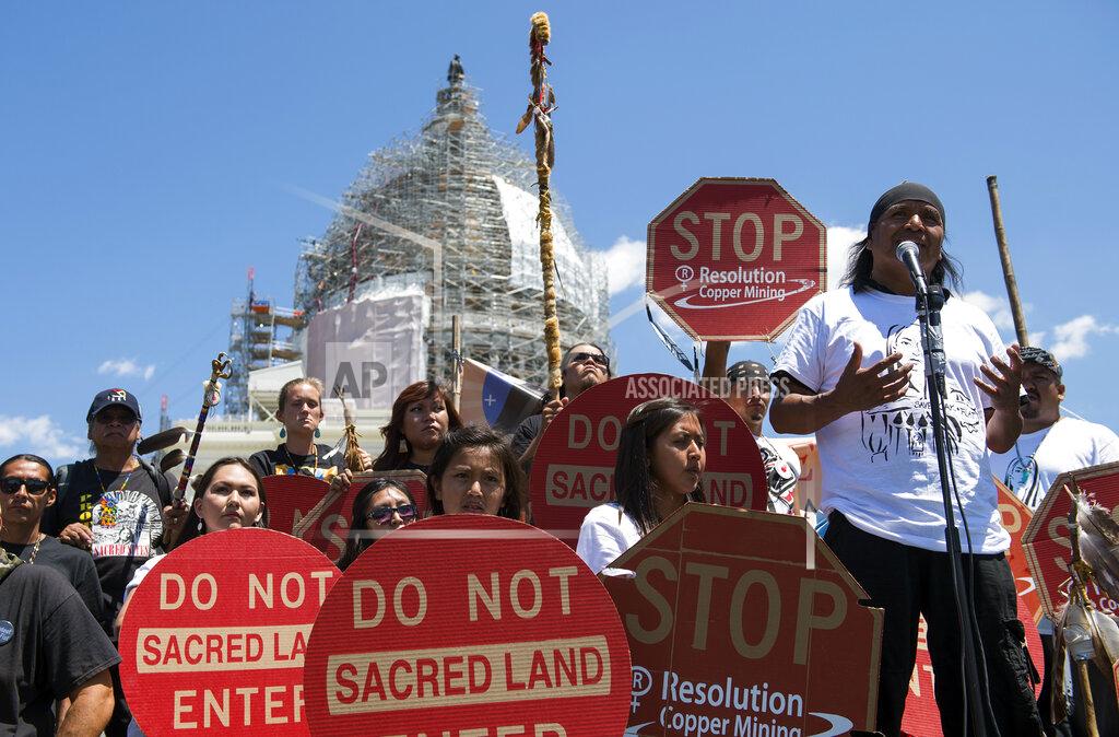 Molly Riley FILE - In this July 22, 2015, file photo, Tribal councilman Wendsler Nosie, Sr. speaks with Apache activists in a rally to save Oak Flat, land near Superior, Ariz., sacred to Western Apache tribes, in front of the U.S. Capitol in Washington. A group of Apaches who have tried for years to reverse a land swap in Arizona that will make way for one of the largest and deepest copper mines in the U.S. sued the federal government Tuesday, Jan. 12, 2021. Apache Stronghold argues in the lawsuit filed in U.S. District Court in Arizona that the U.S. Forest Service cannot legally transfer land to international mining company Rio Tinto in exchange for eight parcels the company owns around Arizona. (AP Photo/Molly Riley, File)