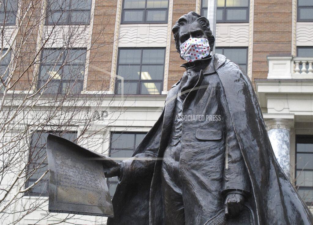 Becky Bohrer A statue of William Seward near the Alaska Capitol is shown outfitted with a mask on Friday, April 24, 2020, in Juneau, Alaska. On Friday, the state began allowing restaurants to resume dine-in service and retail shops and other businesses to reopen, all with limitations, under an initial phase of a plan to restart parts of the economy affected by coronavirus concerns. (AP Photo/Becky Bohrer)