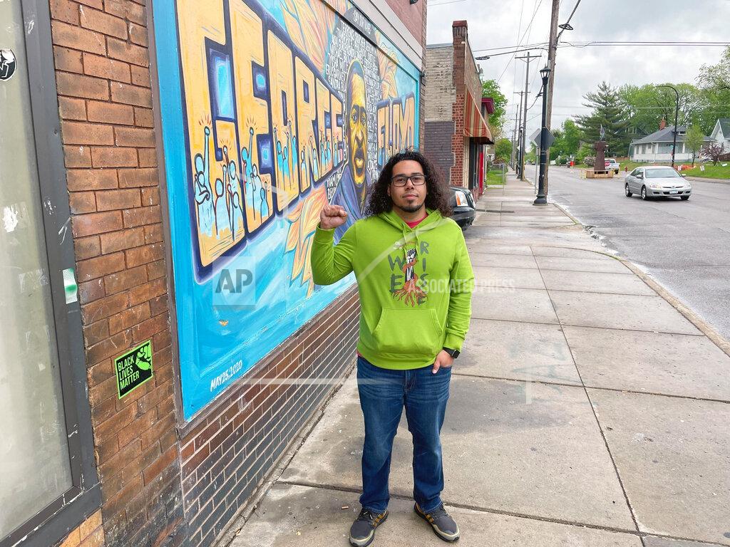 Mohamed Ibrahim Colten Muth, 32, visits George Floyd Square in Minneapolis on Wednesday, May 25, 2022, to mark the second anniversary of the Black man's death at the hands of Minneapolis police officers. Muth said he went there to "make sure I'm paying homage because his sacrifice made a huge impact on the world." Muth, who identifies as mixed race, recalled watching the bystander video of Floyd's dying moments from his home in the Minneapolis suburb of Burnsville. He said it hit him especially hard because he grew up just blocks from the corner where Floyd was killed. (Mohamed Ibrahim/Report for America via AP)