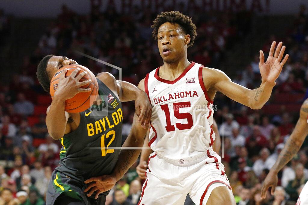 Sue Ogrocki Baylor guard Jared Butler (12) drives around Oklahoma guard Alondes Williams (15) during the first half of an NCAA college basketball game in Norman, Okla., Tuesday, Feb. 18, 2020. (AP Photo/Sue Ogrocki)